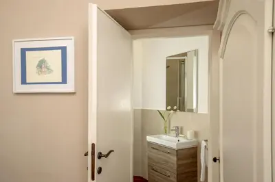 a bathroom with a sink and a mirror at Avignonesi Suites - CA Domus Collection in Rome
