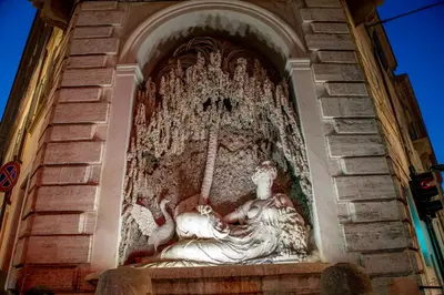 a statue on the side of a building at Avignonesi Suites - CA Domus Collection in Rome