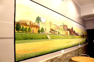 a large painting hanging on a wall at Legends in Rome