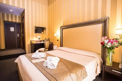 a hotel room with a bed with towels on it at Nice Rome Holiday in Rome