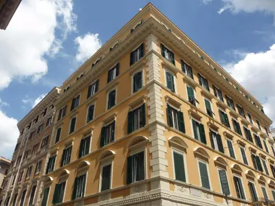 a large yellow building with a triangular top at Nice Rome Holiday in Rome