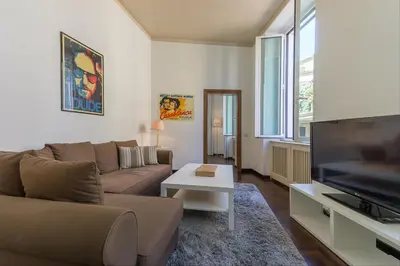 a living room with a couch and a flat screen tv at GuestHost - Palazzo Borghese Lovely Flat in Rome