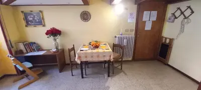 a dining room with a table and a table and chairs at Casa Dino rooms in Rome