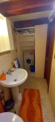 a bathroom with a sink and a toilet and a rug at Casa Dino rooms in Rome