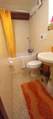 a bathroom with a toilet and a sink and a tub at Casa Dino rooms in Rome