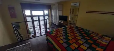 a bedroom with a colorful bed and a window at Casa Dino rooms in Rome