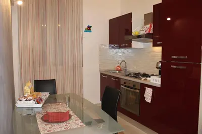 a kitchen with a glass table and a kitchen with a stove at Rome Veniero WelcomeHouse in Rome