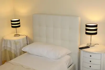 a bedroom with a bed and two lamps on two tables at Rome Veniero WelcomeHouse in Rome