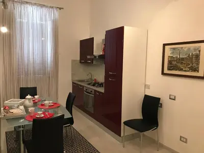 a kitchen with a table and a small kitchen with a dining room at Rome Veniero WelcomeHouse in Rome