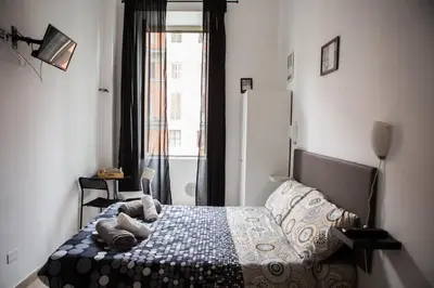 a bedroom with a bed with stuffed animals on it at La Residenza City in Rome