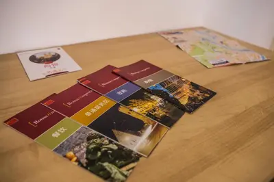 a table topped with pamphlets on top of a wooden table at La Residenza City in Rome