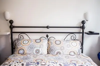 a bed with a black frame and pillows at La Residenza City in Rome
