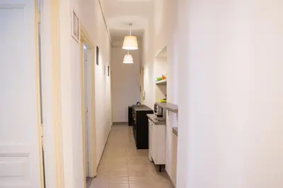 a hallway leading to a kitchen with white walls at La Residenza City in Rome
