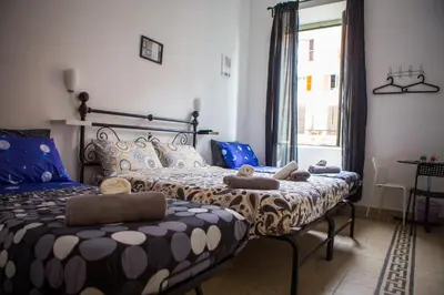 a bedroom with two beds and a window at La Residenza City in Rome