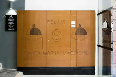 a brown door with a sign for santa maria margaza at Relais Santa Maria Maggiore in Rome