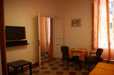 a living room with a table and a television at Tatusa al Colosseo in Rome