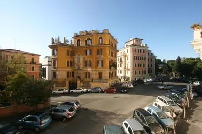 a parking lot with cars parked in front of a building at Tatusa al Colosseo in Rome