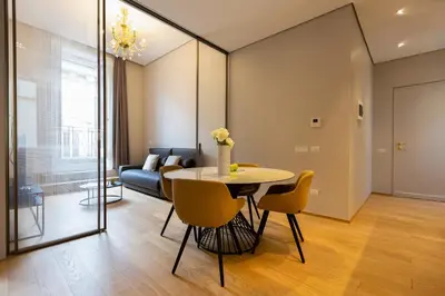 a living room with a table and chairs and a couch at Amazing Piazza Venezia Suites in Rome