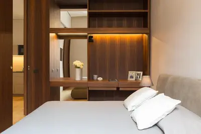 a bedroom with a bed and a desk with a mirror at Amazing Piazza Venezia Suites in Rome