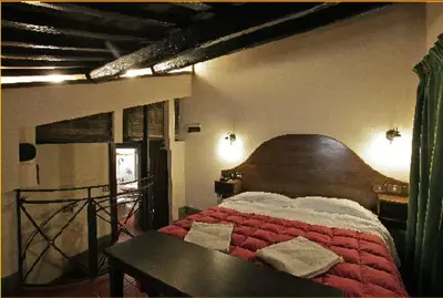a bedroom with a large bed with a wooden headboard at Hotel Panda in Rome