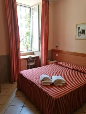 a bedroom with a bed with two towels on it at Palma Residences In Rome in Rome