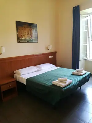 a bedroom with a bed with two towels on it at Palma Residences In Rome in Rome