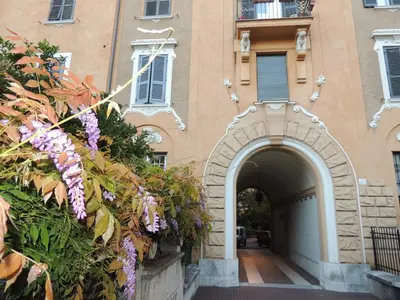 an entrance to a building with purple flowers at Palma Residences In Rome in Rome