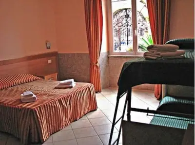a hotel room with a bed and a window at Palma Residences In Rome in Rome