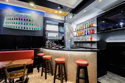 a bar with orange stools in a restaurant at Alessandro Palace & Bar in Rome