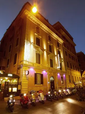 a group of people sitting around a table drinking at Alessandro Palace & Bar in Rome