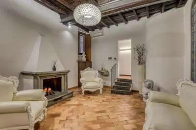 a living room with chairs and a fireplace at Easybnb - Luxury Navona in Rome