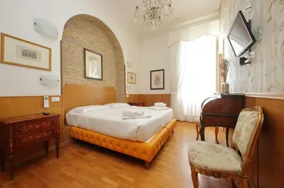 a bedroom with a bed and a table and a chair at Sonnino Suite in Rome