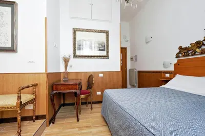 a bedroom with a bed and a table and a chair at Sonnino Suite in Rome
