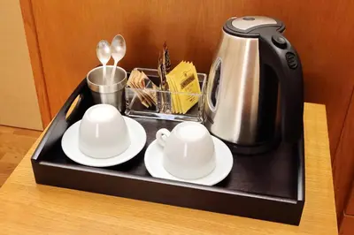 a tray with two cups and a coffee maker at Sonnino Suite in Rome