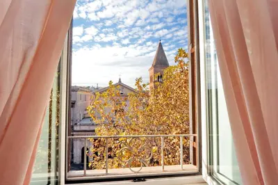 an open window with a view of a tree at Sonnino Suite in Rome