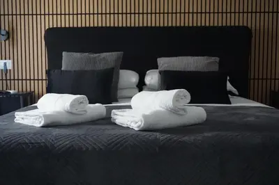 two towels sitting on top of a bed at VMH Vatican Modern House in Rome