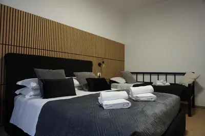 two beds in a room with towels on them at VMH Vatican Modern House in Rome