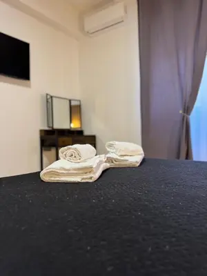 two towels sitting on a bed in a room at VMH Vatican Modern House in Rome