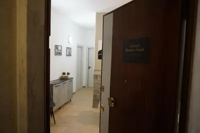 a door with a sign that reads next new house at VMH Vatican Modern House in Rome