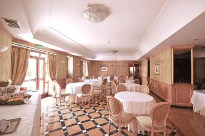 a dining room with white tables and chairs at Hotel Cilicia in Rome