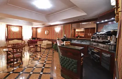 a living room with a kitchen and a dining room at Hotel Cilicia in Rome