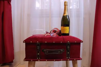 a bottle of champagne sitting on top of a suitcase at Lorenz Suites Trastevere Hill in Rome