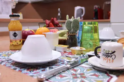 a table with cups and saucers on a kitchen counter at Lorenz Suites Trastevere Hill in Rome