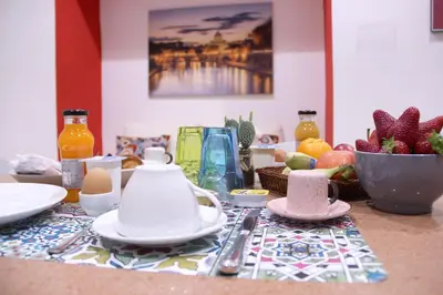a table with a table cloth with a tea set at Lorenz Suites Trastevere Hill in Rome