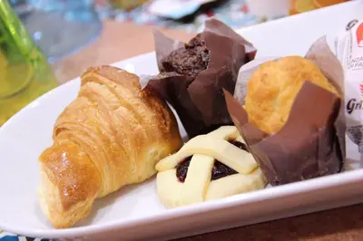 a plate of pastries and other desserts on a table at Lorenz Suites Trastevere Hill in Rome