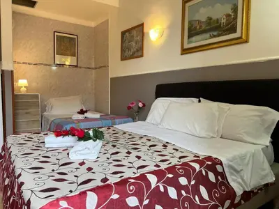 a hotel room with a bed with flowers on it at Affitacamere Radi in Rome