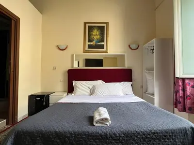 a bedroom with a bed with a towel on it at Affitacamere Radi in Rome