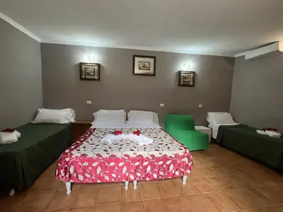 a room with a bed and two green beds at Affitacamere Radi in Rome