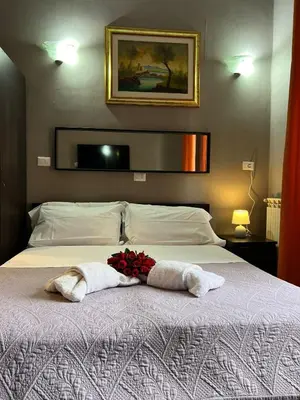 a bedroom with a bed with two towels on it at Affitacamere Radi in Rome