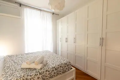 a bedroom with white cabinets and a bed with two towels at Borgo Vittorio St. Peter Apartments in Rome